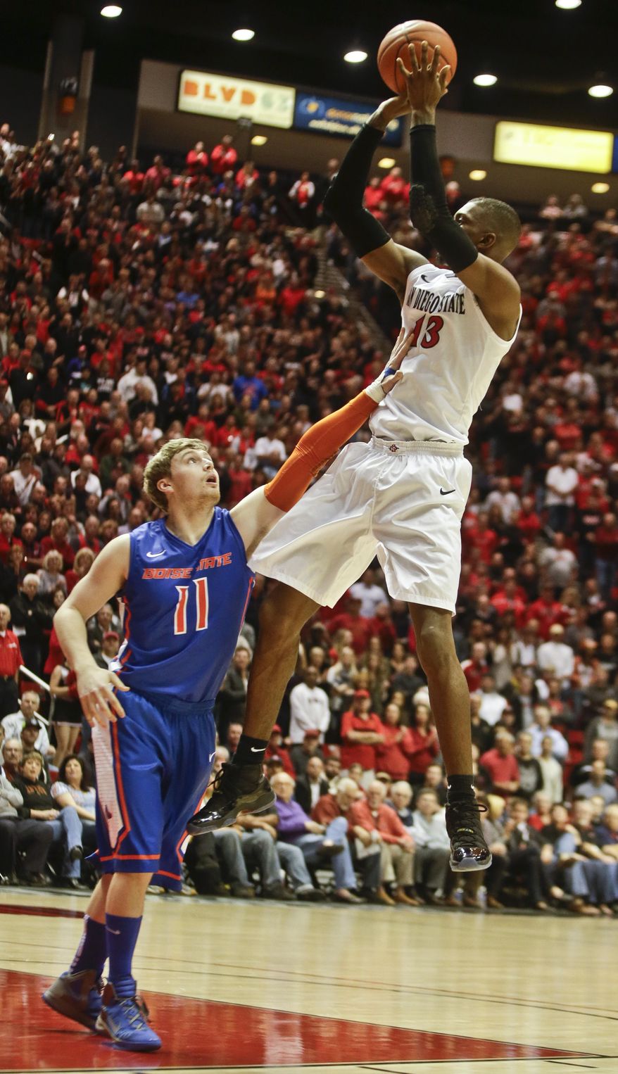 San Diego State forward Winston Shepard shoots over Boise State guard Jeff Elorriaga during the first half of a NCAA college basketball game Wednesday, Jan. 8, 2014, in San Diego. (AP Photo/Lenny Ignelzi)