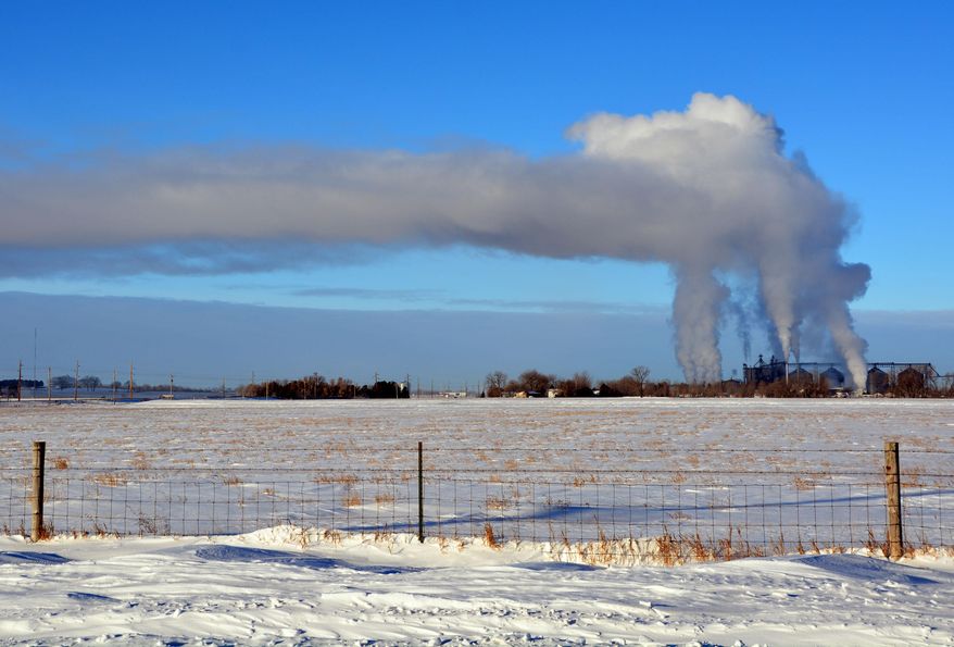 In this photo taken on Wednesday, Jan. 8, 2014, Steam rises in subzero temperatures and drifts south from the Glacial Lakes Energy ethanol plant in Watertown, S.D. (AP Photo/Dirk Lammers)