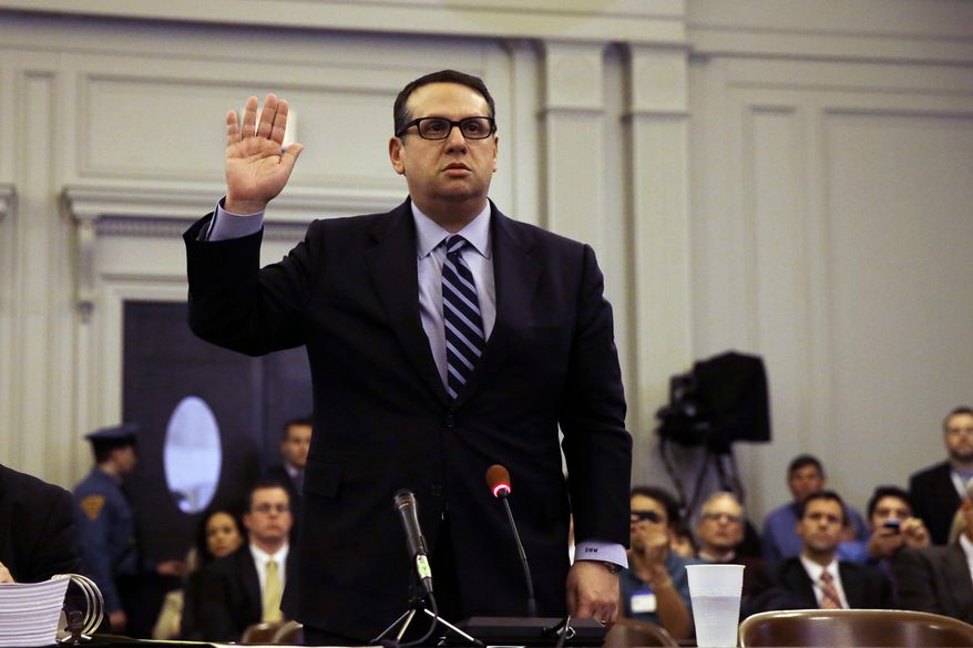 David Wildstein takes an oath during a hearing Thursday, Jan. 9, 2014, at the Statehouse in Trenton, N.J. Wildstein, a former appointee of Gov. Chris Christie, is refusing to answer questions from a legislative committee looking into a scandal involving punitive traffic lane closures. The Christie administration stands accused of closing lanes on the George Washington Bridge, linking New York and New Jersey, in order to create a huge traffic backup as retribution against a local mayor for not endorsing the governor’s reelection. (AP Photo/Mel Evans)