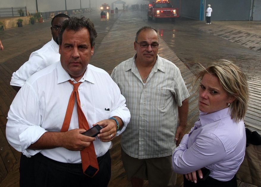In this Sept. 12, 2013 photo provided by the Office of the Governor of New Jersey, Deputy Chief of Staff Bridget Anne Kelly, right, stands with Gov. Chris Christie, left, during a tour of the Seaside Heights, N.J. boardwalk after it was hit by a massive fire. Christie fired Kelly Thursday, Jan. 9, 2014, and apologized over and over for his staff's "stupid" behavior, insisting during a nearly two-hour news conference that he had no idea anyone around him had engineered traffic jams as part of a political vendetta against a Democratic mayor. (AP Photo/Office of Gov. Chris Christie, Tim Larsen)