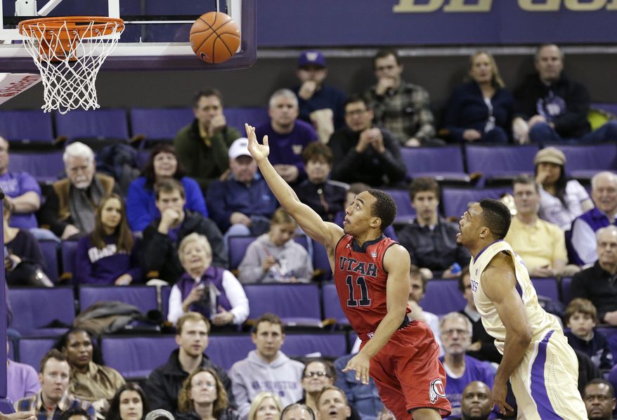 Utah's Brandon Taylor (11) puts a shot up in front of Washington's Darin Johnson during the first half of an NCAA college basketball game Wednesday, Jan. 8, 2014, in Seattle. (AP Photo/Elaine Thompson)