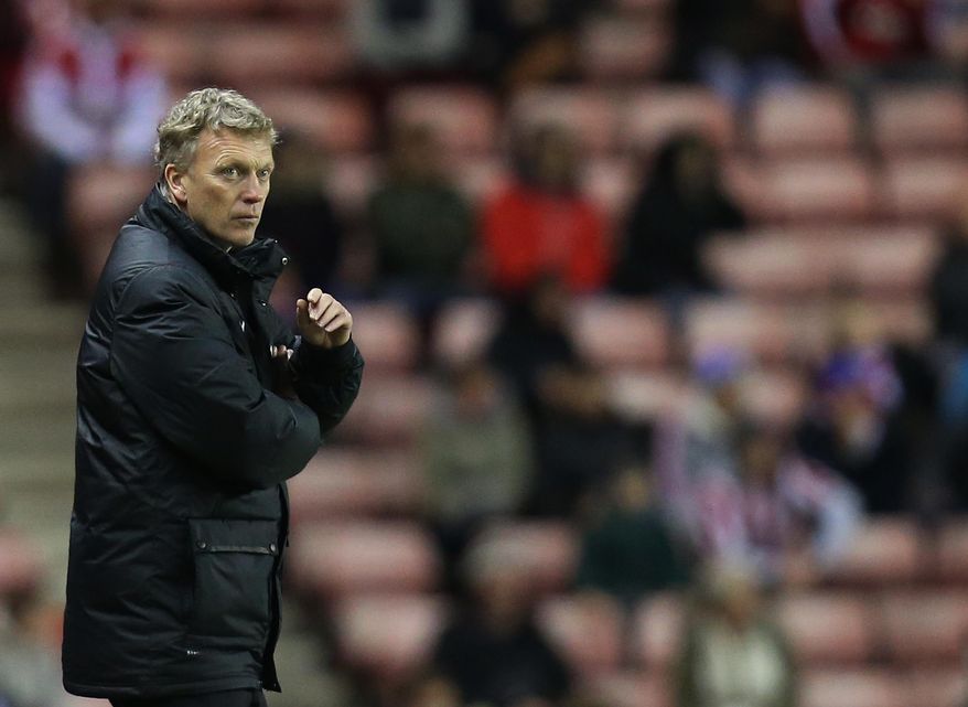 Manchester United's manager David Moyes stands dejected after being defeated by Sunderland at the end of their English League Cup semifinal first leg soccer match at the Stadium of Light, Sunderland, England, Tuesday, Jan. 7, 2014. (AP Photo/Scott Heppell)