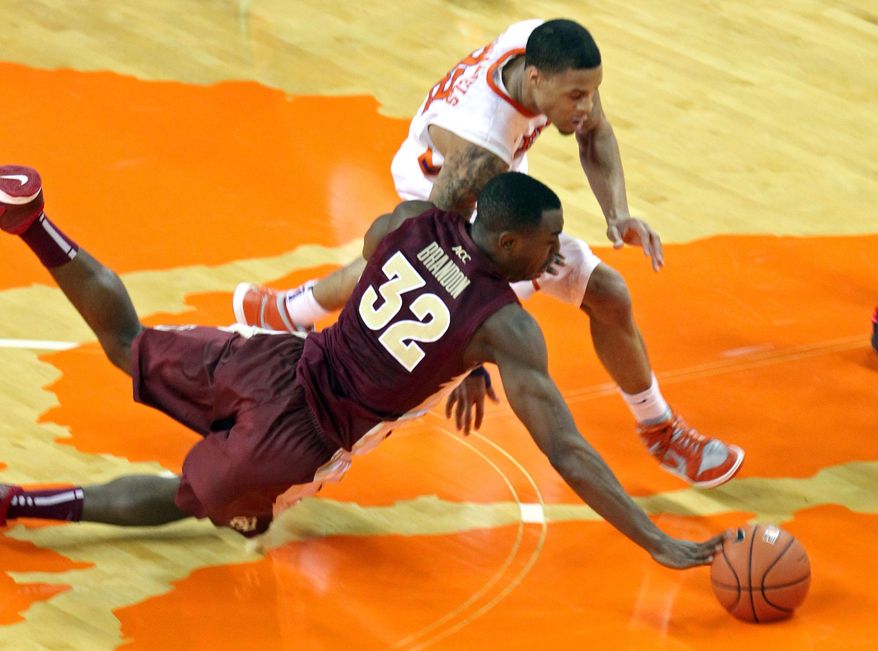 Florida State's Montay Brandon (32) dives for a loose ball in front of Clemson's K.J. McDaniels during the second half of an NCAA college basketball game at Littlejohn Coliseum in Clemson, S.C., on Thursday, Jan. 9, 2014. (AP Photo/Anderson Independent-Mail, Mark Crammer) GREENVILLE NEWS OUT SENECA JOURNAL OUT