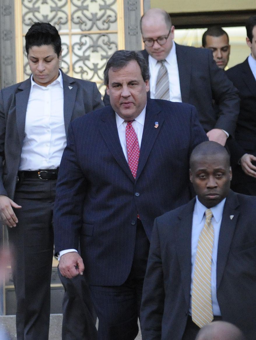New Jersey Gov. Chris Christie leaves City Hall Thursday, Jan. 9, 2014, in Fort Lee, N.J. Christie traveled to Fort Lee to apologize in person to Mayor Mark Sokolich. Moving quickly to contain a widening political scandal, Christie fired one of his top aides Thursday and apologized repeatedly for the "abject stupidity" of his staff, insisting he had no idea anyone around him had engineered traffic jams to get even with a Democratic mayor. (AP Photo/Louis Lanzano)