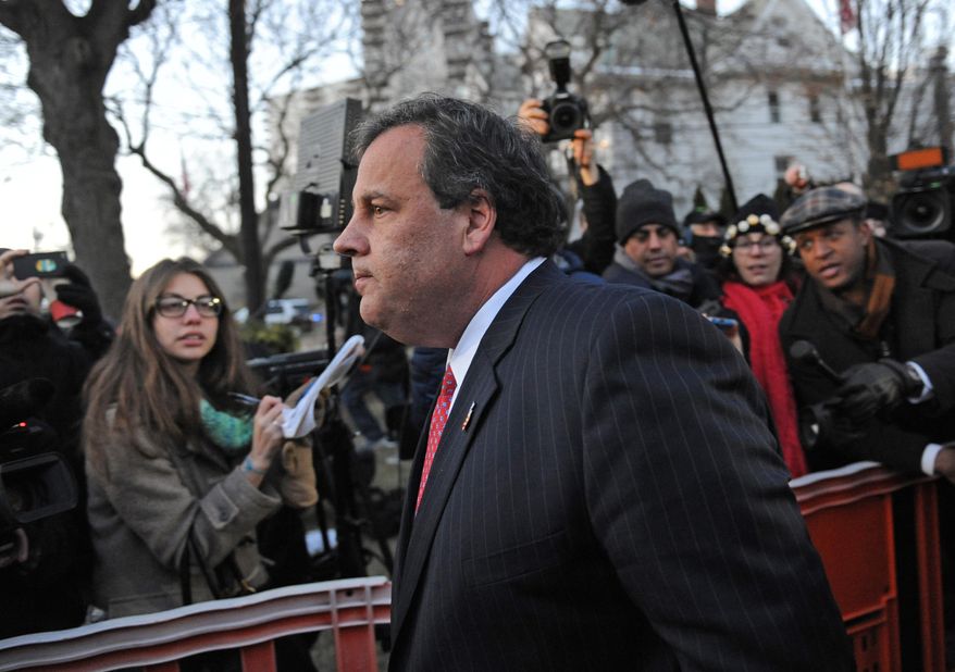 New Jersey Gov. Chris Christie walks past reporters as he leaves City Hall Thursday, Jan. 9, 2014, in Fort Lee, N.J. Christie traveled to Fort Lee to apologize in person to Mayor Mark Sokolich. Moving quickly to contain a widening political scandal, Gov. Chris Christie fired one of his top aides Thursday and apologized repeatedly for the "abject stupidity" of his staff, insisting he had no idea anyone around him had engineered traffic jams to get even with a Democratic mayor. (AP Photo/Louis Lanzano)