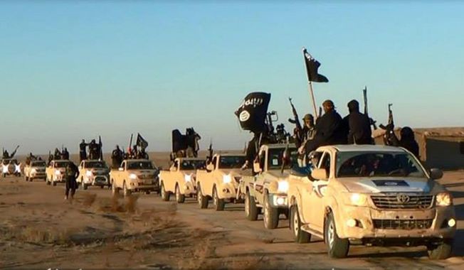 This image posted on a militant website on Tuesday, Jan. 7, 2014, which is consistent with AP reporting, shows a convoy of vehicles and fighters from the al-Qaida linked Islamic State of Iraq and the Levant (ISIL) fighters in Iraq&#x27;s Anbar Province. With al-Qaida linked fighters and allied tribal gunmen camped on the outskirts, a tentative calm took hold over Fallujah on Friday, Jan. 10, 2014 and residents started to return to the besieged city west of Baghdad. Government forces were stationed nearby as sporadic street fighting breaks out in other cities. The picture painted by residents, officials and international groups suggests that both the militants and government forces are preparing for a long standoff with civilians caught in the middle.(AP Photo via militant website)