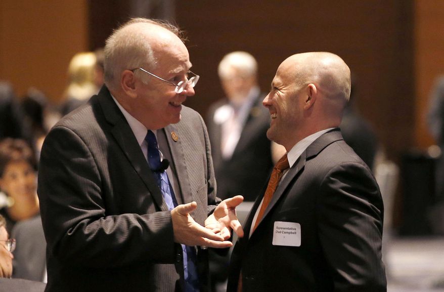 Arizona Speaker of The House Andy Tobin, left, R-Dewey, talks with House Minority Leader Chad Campbell, D-Phoenix, at the annual Arizona Chamber of Commerce and Industry legislative luncheon Friday, Jan. 10, 2014, in Phoenix. Leaders of the state's business community heard from Gov. Jan Brewer and the Legislature's top leaders at the yearly pre-legislative session luncheon. (AP Photo/Ross D. Franklin)