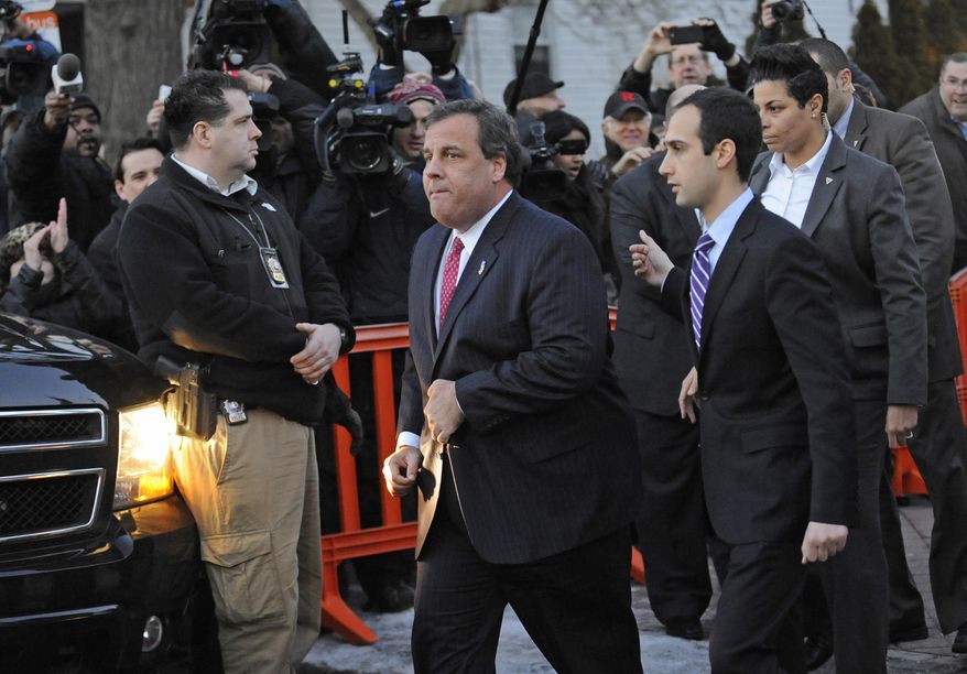 New Jersey Gov. Chris Christie walks past reporters as he leaves City Hall Thursday, Jan. 9, 2014, in Fort Lee, N.J. Christie traveled to Fort Lee to apologize in person to Mayor Mark Sokolich. Moving quickly to contain a widening political scandal, Gov. Chris Christie fired one of his top aides Thursday and apologized repeatedly for the "abject stupidity" of his staff, insisting he had no idea anyone around him had engineered traffic jams to get even with a Democratic mayor. (AP Photo/ Louis Lanzano)