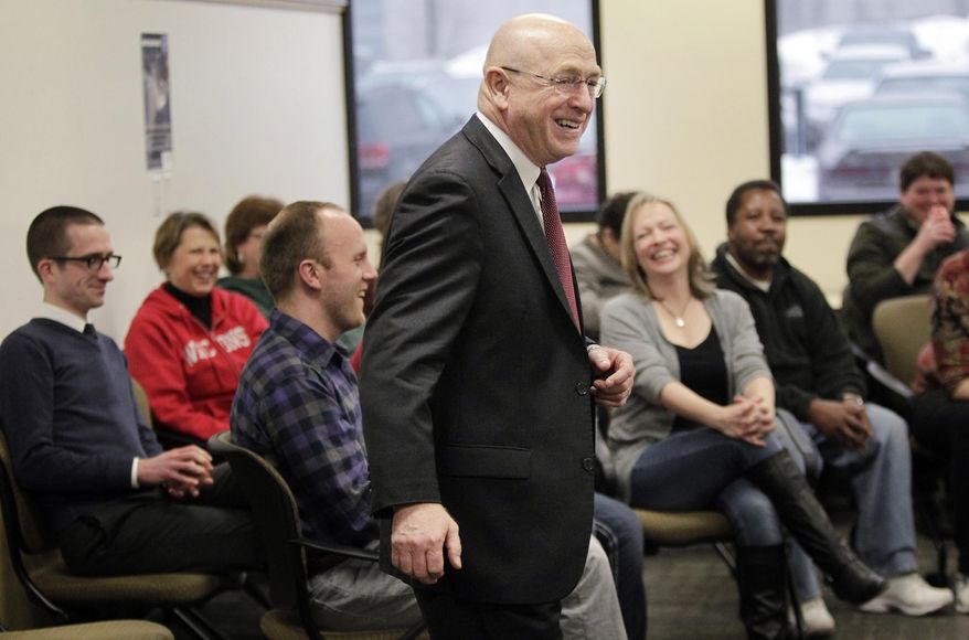 Ray W. Cross, the newly appointed president of the University of Wisconsin System, talks with his administration employees during a meet and greet event in Madison, Wis., Friday, Jan. 10, 2014. (AP Photo/Wisconsin State Journal, M.P. King)