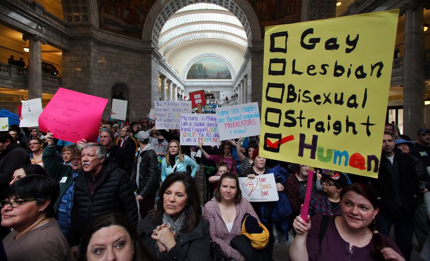 Supporters of gay marriage fill the rotunda as they gathered to rally at the Utah State Capitol Friday Jan. 10. 2014, and deliver a petition with over 58,000 signatures in support of gay marriage to Utah Governor Gary Herbert. (AP Photo/Steve C. Wilson)