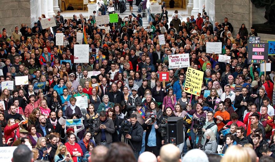 Supporters of gay marriage fill the rotunda as they gathered to rally at the Utah State Capitol Friday Jan. 10, 2014, and  to deliver a petition with over 58,000 signatures in support of gay marriage to Utah Governor Gary Herbert.  (AP Photo/Steve C. Wilson)