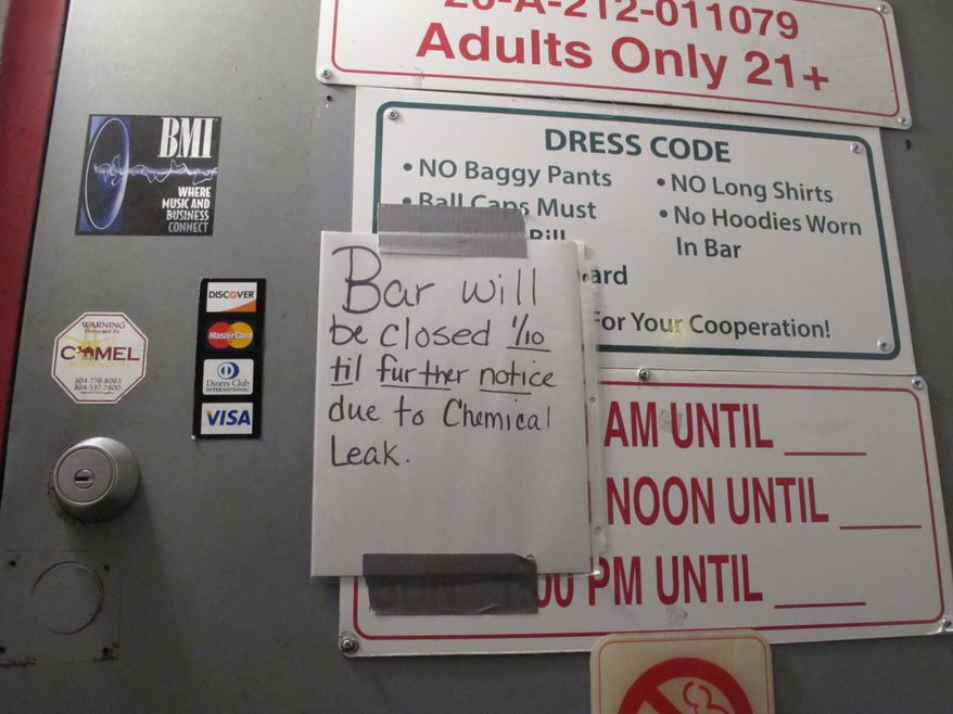 A sign outside the Red Carpet, a bar popular with Capitol employees, notifying customers it's closed because of a chemical spill that caused a do-not-use order for the water supply in the capital and surrounding areas on Thursday, Jan. 9, 2014 in Charleston, W.Va. (AP Photo/Brendan Farrington)