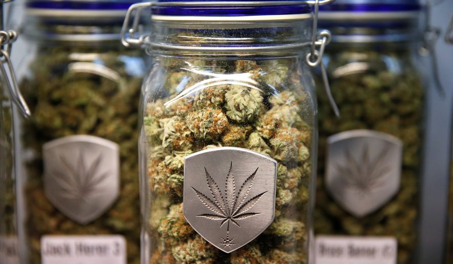 Different strains of pot are displayed for sale at Medicine Man marijuana dispensary in Denver, Friday Dec. 27, 2013. (AP Photo/Brennan Linsley)