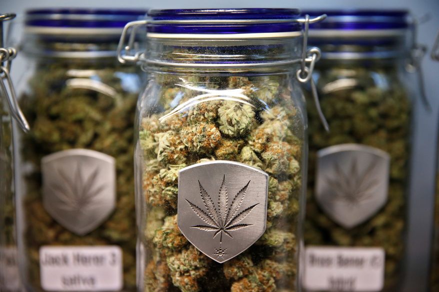 Different strains of pot are displayed for sale at Medicine Man marijuana dispensary in Denver, Friday Dec. 27, 2013. (AP Photo/Brennan Linsley)