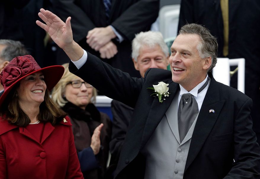 Virginia Gov. Terry McAuliffe waves to supporters alongside his wife, Dorothy, on Saturday during inaugural ceremonies at the Capitol in Richmond. Former U.S. Secretary of State Hillary Rodham Clinton and former President Bill Clinton look on in the background. (associated press)