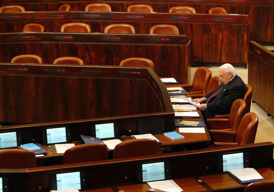 FILE - In this Monday, Oct. 25, 2004 file photo, Israeli Prime Minister Ariel Sharon prepares for his opening speech during a special session in the Knesset, Israel's parliament, about his government's proposed "disengagement plan" in Jerusalem. Sharon, the hard-charging Israeli general and prime minister who was admired and hated for his battlefield exploits and ambitions to reshape the Middle East, died Saturday, Jan. 11, 2014. He was 85. (AP Photo/Oded Balilty, File)