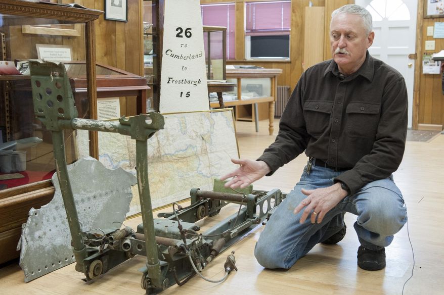 In this Jan. 7, 2014 photo, Rick Lewis speaks about the remnants of an ejector seat recovered from an Air Force B-52 bomber that crashed 50 years ago is displayed at the Grantsville Community Museum in Grantsville, Md., near the site of the 1964 crash. Residents of far western Maryland are recalling the 50th anniversary of the deadly crash. Three of the five crew members died in the storm-driven accident on Jan. 13, 1964. Local volunteers helped government workers recover the bodies and two unarmed nuclear bombs from the snow-covered scene. (AP Photo/Andrew Ferguson)