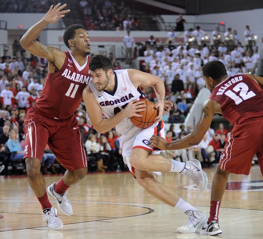 Alabama forward Shannon Hale (11) tries to stop Georgia forward Nemanja Djurisic (42) drive to the basket during the first half of an NCAA college basketball game Saturday, Jan. 11, 2014, in Athens, Ga. (AP Photo/The Banner-Herald, Richard Hamm) MAGS OUT; MANDATORY CREDIT