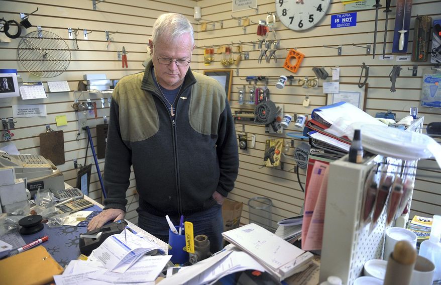 In this Dec. 17, 2013 photo, fourth-generation owner Jeff Wilcox works on a quiet day at his family's business, Wilcox Marine Supply, in Stonington, Conn. Wilcox is shutting the 135-year-old family marine supply business in early 2014, a casualty in the battle over federal fishing limits. (AP Photo/ The Day, Tim Cook) MANDATORY CREDIT