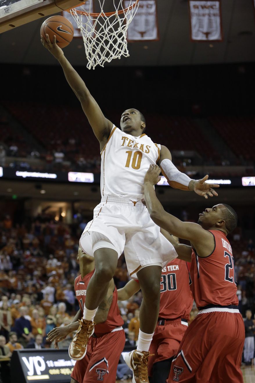 Texas' Jonathan Holmes (10) scores over Texas Tech's Toddrick Gotcher, right, during the first half of an NCAA college basketball game on Saturday, Jan. 11, 2014, in Austin, Texas. (AP Photo/Eric Gay)