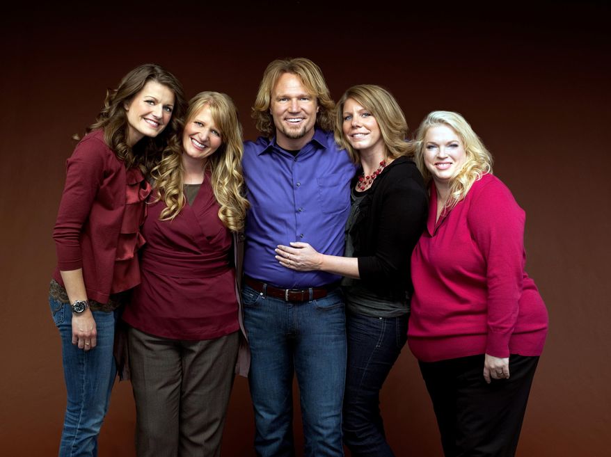 FILE - In this file publicity photo provided by TLC, Kody Brown, center, poses with his wives, from left, Robyn, Christine, Meri and Janelle, in a promotional photo for the reality series, "Sister Wives," which aired in March 2011. When the polygamous family learned in December 2013 that a federal judge in Utah struck down key parts of the state's polygamy laws, Brown and his four wives said they cried and felt deeply emotional. The family said they are grateful for the ruling, but said winning the lawsuit they brought against Utah in July 2011 doesn’t ease the pain caused by the significant personal sacrifices they made when they fled the state for Las Vegas under the threat of prosecution. (AP Photo/TLC, George Lange, File)