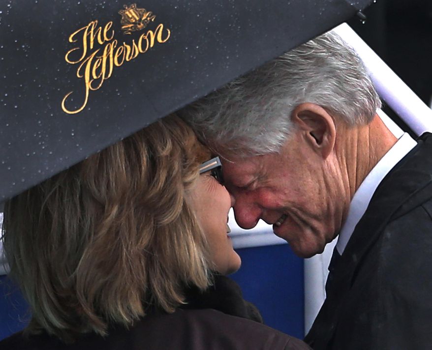 Former President Bill Clinton and his wife, former Secretary of State Hillary Rodham Clinton, share a moment under an umbrella before the rainy inauguration of democratic Virginia Gov. Terry McAuliffe in Richmond, Va., Jan. 11, 2014. The umbrella came from the five-star Jefferson Hotel. (AP Photo/Richmond Times-Dispatch, P. Kevin Morley)