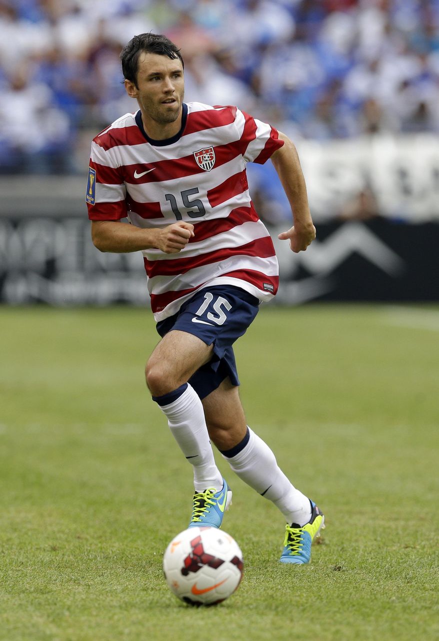 FILE - In this July 21, 2013 file photo, United States' Michael Parkhurst dribbles the ball during the first half in the quarterfinals of the CONCACAF Gold Cup soccer tournament against El Salvador, in Baltimore. Parkhurst is following Clint Dempsey and Michael Bradley back to Major League Soccer, leaving Augsburg of the Bundesliga to sign with the Columbus Crew. Augsburg said Monday, Jan. 13, 2014, that Parkhurst's contract, which ran until June 2015, was terminated by mutual consent. The Crew obtained the rights of MLS's 2007 Defender of the Year from New England for Columbus' first-round pick in Thursday's draft and allocation money. (AP Photo/Patrick Semansky, File)