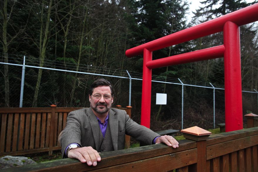 SNBL vice president for business development Mark Crane looks out from the Shinto shrine his company built at the Japanese-owned SNBL USA facility in Everett, Wash., on Friday, Jan. 10, 2014. It is one of the largest laboratories on the West Coast for research with monkeys. (AP Photo/The Herald, Dan Bates)