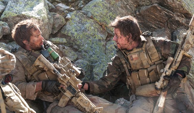 FILE - This file photo released by Universal Pictures shows Taylor Kitsch, left, as Michael Murphy and Mark Wahlberg as Marcus Luttrell in a scene from the film, “Lone Survivor.&amp;quot; The Navy SEAL drama earned $37.8 million in its first weekend of wide release. (AP Photo/Universal Pictures, Gregory R. Peters, File)