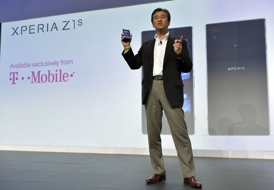 Kunimasa Suzuki, executive vice president, Sony Corporation and president and chief executive officer of Sony Mobile Communications, unveils the new Sony EXPERIA Z1s during the Sony news conference at the International Consumer Electronics Show Monday, Jan. 6, 2014, in Las Vegas. The phone will be sold exclusivley by T-Mobile. (AP Photo/Jack Dempsey)