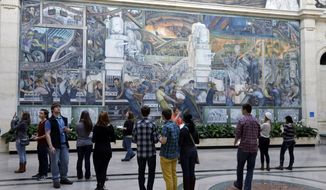 FILE - In this Dec. 10, 2013 file photo visitors look at the Detroit Industry Murals by the Diego Rivera at the Detroit Institute of Arts in Detroit. National and local foundations have committed more than $330 million toward the pensions for Detroit’s public workers in an effort to stave off the sale of city owned art masterpieces as part of a historic bankruptcy, mediators said Monday, Jan. 13, 2014. (AP Photo/Carlos Osorio)