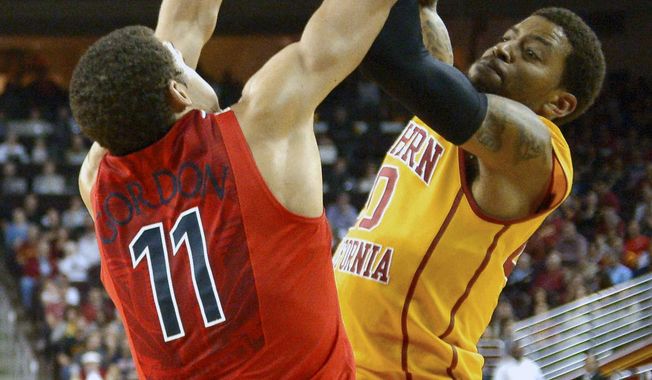 Southern California guard J.T. Terrell, right, has his shot blocked by Arizona forward Aaron Gordon during the first half of an NCAA college basketball game, Sunday, Jan. 12, 2014, in Los Angeles. (AP Photo/Mark J. Terrill)