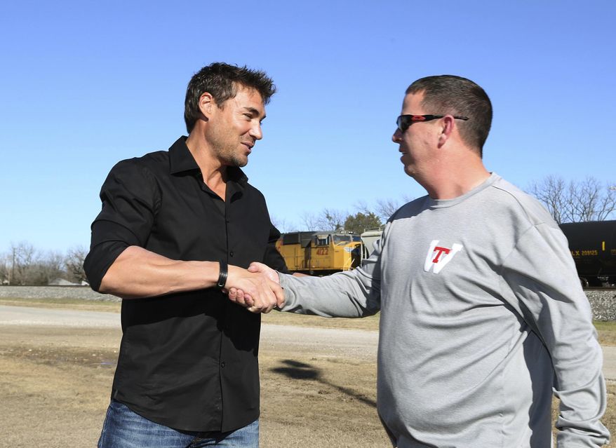 Former major league baseball player Scott Podsednik, left, shakes hand with longtime friend and West high school baseball coach Cory Beckham on Tuesday, Jan. 14, 2014 in, West, Texas. Podsednik, a West native, was part of the Texas Rangers caravan during a program at the West Community Center. West was devastated by a deadly fertilizer plant explosion last year. The team has donated $50,000 to help renovate a park across from the plant site with a new playground and a memorial to the 15 people killed in the explosion. (AP Photo/Waco Tribune Herald, Rod Aydelotte)