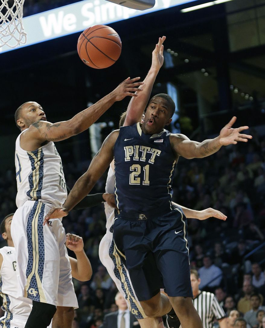 Pittsburgh forward Lamar Patterson (21) passes as Georgia Tech forward Kammeon Holsey (24) defends in the first half of an NCAA college basketball game, Tuesday, Jan. 14, 2014, in Atlanta. (AP Photo/John Bazemore)