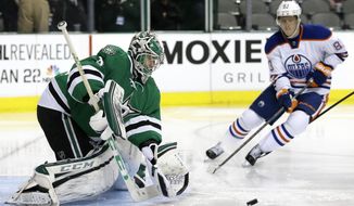 Dallas Stars&#39; Kari Lehtonen (32) of Finland prepares to glove a shot under pressure from Edmonton Oilers right wing Ales Hemsky (83) of Czech Republic in the second period of an NHL Hockey game, Tuesday, Jan. 14, 2014, in Dallas. (AP Photo/Tony Gutierrez)