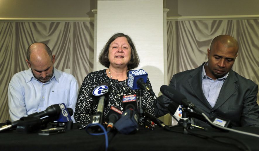 FILE - In this April 9, 2013, file photo, former NFL player Dorsey Levens, right, extends a hand as Mary Ann Easterling, the widow of former NFL player Ray Easterling, reacts as former NFL player Kevin Turner, left, looks on during a news conference in Philadelphia, after a hearing to determine whether the NFL faces years of litigation over concussion-related brain injuries. Judge Anita Brody has announced on Thursday, Aug. 29, 2013, that the NFL and more than 4,500 former players want to settle concussion-related lawsuits for $765 million. (AP Photo/Matt Rourke, File)