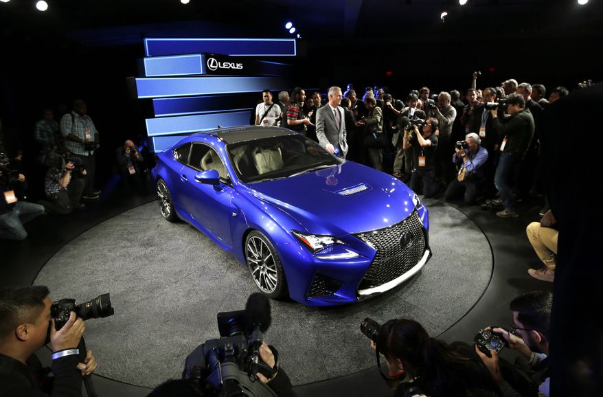 Lexus Group Vice President and General Manager Jeff Bracken reveals the new Lexus RC F Coupe at the North American International Auto Show in Detroit, Tuesday, Jan. 14, 2014. (AP Photo/Carlos Osorio)