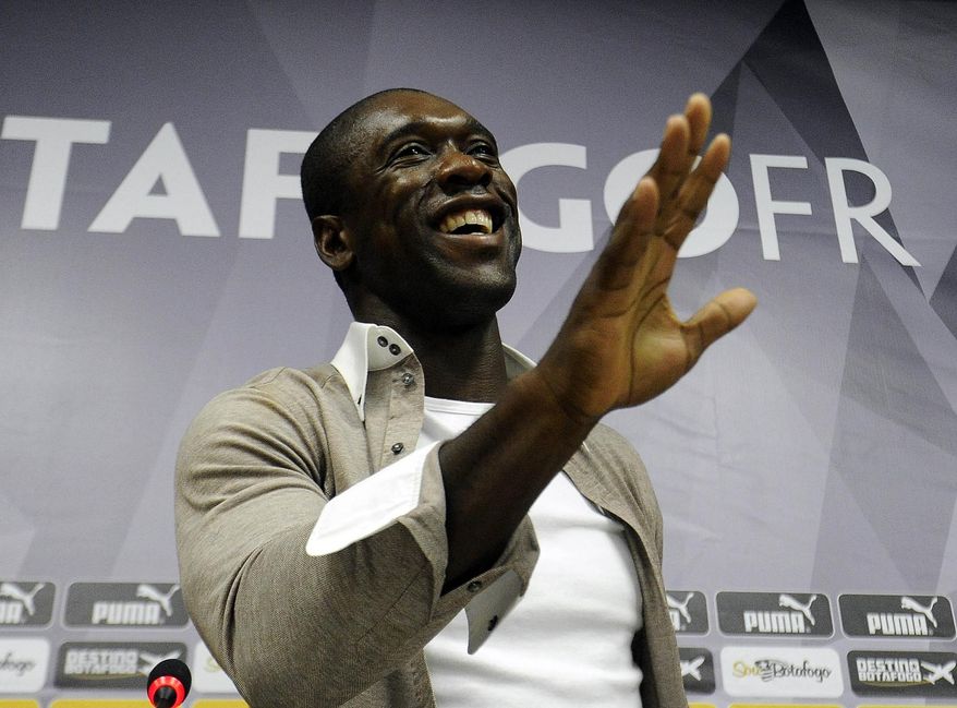 Dutch soccer player Clarence Seedorf gestures at a press conference at the Brazilian club Botafogo, where the midfielder has been playing in Rio de Janeiro, Brazil, Tuesday, Jan. 14, 2014. Seedorf said Tuesday he will take over as the new coach at AC Milan, replacing Massimiliano Allegri who was fired the day before. (AP Photo/Fabio Castro, AGIF)
