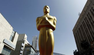 FILE - In this Feb. 25, 2012 file photo, a Oscar statue is seen on the red carpet before the 84th Academy Awards in Los Angeles. The producers of the 86th annual Academy Awards say this year&#39;s ceremony will honor big-screen, real-life heroes, superheroes, popular heroes and animated heroes, both past and present, as well as the filmmakers who bring them to life. Craig Zadan and Neil Meron said Tuesday, Jan. 14, 2014, that they wanted to unify the March 2 show with an entertaining and emotional theme.  (AP Photo/Matt Sayles, File)