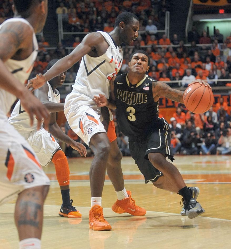 Purdue guard Ronnie Johnson (3) collides with Illinois' Nnanna Egwu (32) during the second half of an NCAA college basketball game Wednesday, Jan. 15, 2014, in Champaign, Ill. (AP Photo/Rick Danzl)