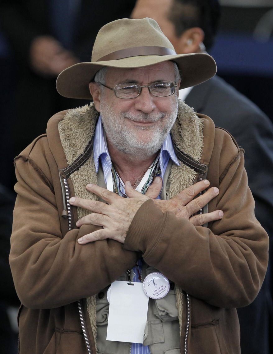 ADDS DATE OF ARREST - FILE - In this June 23, 2011 file photo, Mexican poet and peace activist Javier Sicilia holds his hands over his chest during a meeting in Mexico City. Mexican authorities say they arrested on Tuesday, Jan. 14, 2014, an alleged drug trafficker as a suspect in the killing of Sicilia's only child. Sicilia's son, Juan, and six friends were abducted by gunmen while leaving a nightclub in Cuernavaca, and their bodies were found abandoned near the city. The killing led Sicilia to become a vocal critic of the Mexican government's military crackdown on drug cartels. (AP Photo/Eduardo Verdugo, File)