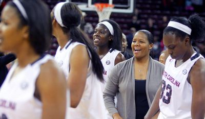 In this Nov. 8, 2013 photo, University of South Carolina assistant coach Nikki McCray, second from right, celebrates with the team after defeating Charleston Southern in Columbia, S.C.  McCray says she's being treated for breast cancer.  McCray said Monday, Jan. 13, 2014, she was diagnosed in November and was told by doctors her condition was treatable. McCray says she'll continue coaching through the season, if possible. (AP Photo/The State, Tracy Glantz) ALL LOCAL MEDIA OUT, (TV, ONLINE, PRINT) MBI