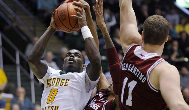 George Mason&#x27;s Bryon Allen (0) goes to the basket against Massachusetts forward Raphiael Putney, center, and Tyler Bergantino (11) during the second half of an NCAA college basketball game, Wednesday, Jan. 15, 2014, in Fairfax, Va. Massachusetts won 88-87. (AP Photo/Nick Wass)
