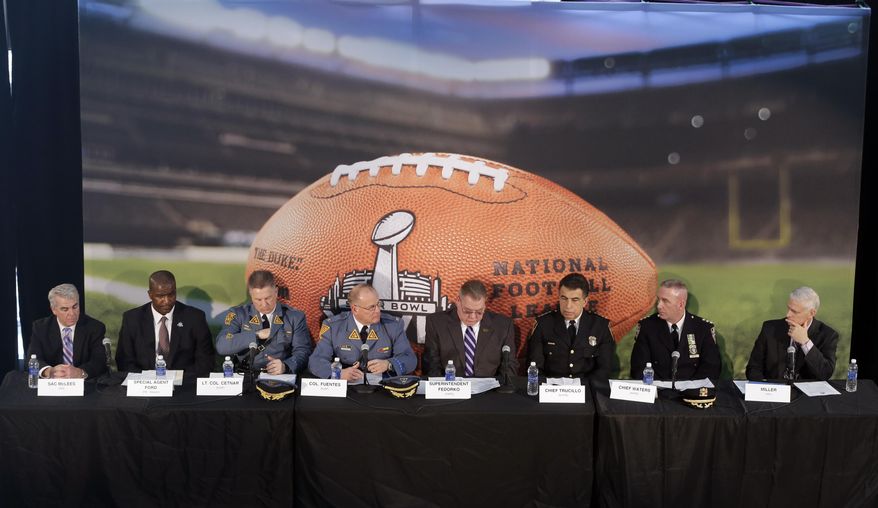 Officials, from left, Homeland Security Investigations special agent in charge Andrew McLees, FBI special agent in charge Aaron Ford, New Jersey State Police Lt. Col. Edward Cetnar, New Jersey State Police Col. Rick Fuentes, Port Authority Police Department Superintendent Michael Fedorko, New Jersey Transit Police Chief Christopher Trucillo, New York Police Department Chief James Waters and NFL chief security officer Jeffrey Miller sit together during a news conference highlighting the security measures set for Super Bowl XLVIII at MetLife Stadium, Wednesday, Jan. 15, 2014, in East Rutherford, N.J. Police officials say security for the Super Bowl will include about 4,000 government and private officers assigned to the stadium on game day. Fans arriving at the game by mass transit on Feb. 2 will encounter a security perimeter extending 300 feet from entrances to the stadium. They'll be funneled into temporary pavilions for airport-style screening. (AP Photo/Julio Cortez)