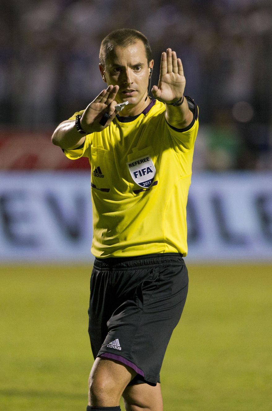FILE - In this Tuesday Sept. 10, 2013 file photo, referee Mark Geiger signals a call at a 2014 World Cup qualifier soccer match between Honduras and Panama in Tegucigalpa, Honduras. FIFA selected referee Mark Geiger on Wednesday Jan. 15, 2014, as one of the 25 who will officiate at the 2014 World Cup soccer tournament in Brazil. (AP Photo/Moises Castillo, File)