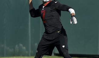 San Francisco 49ers quarterback Colin Kaepernick (7) practices at an NFL football training facility in Santa Clara, Calif., Wednesday, Jan. 15, 2014. The 49ers are scheduled to play the Seattle Seahawks for the NFC Championship on Sunday. (AP Photo/Jeff Chiu)