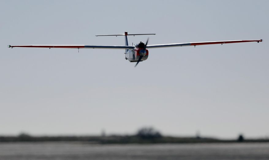 A test drone with a wing span of almost 13 feet flies over a ranch near Sarita, Texas, Wednesday, Jan. 15, 2014. A Texas A&M Corpus Christi research team is conducting tests to help determine how unmanned aircraft system can be integrated into existing airspace. (AP Photo/Eric Gay)