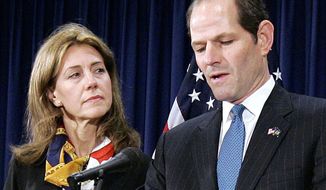 FILE - In this March 12, 2008, file photo, New York Gov. Eliot Spitzer announces his resignation amid a prostitution scandal as his wife Silda stands by at the governor’s office in New York. A spokeswoman for Spitzer and his wife says the two have resolved all issues as they part ways after 26 years of marriage. The couple announced in December 2013 that they were splitting up.  (AP Photo/Stephen Chernin, File)