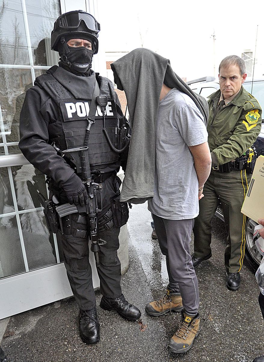 FILE - In this Jan. 16, 2013 file photo, a suspect is taken into custody in Bennington, Vt., one of dozens of suspects rounded up in southwestern Vermont on charges related to the distribution and sale of illicit drugs. In his State of the State address on Jan. 8, 2014, Gov. Peter Shumlin called for treatment and education in addition to law enforcement as the best way to meet the state's growing challenge from the abuse of heroin and other opiates, which are fueling crime and wrecking lives of families in the state. (AP Photo/The Banner, Peter Crabtree, File)