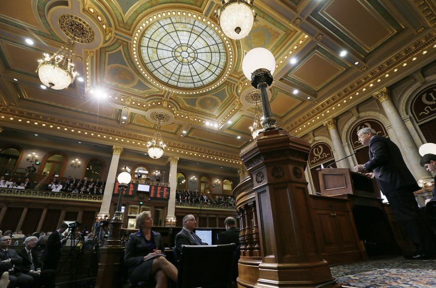 Iowa Gov. Terry Branstad, right, delivers his Condition of the State address before a joint session of the Iowa Legislature, Tuesday, Jan. 14, 2014, at the Statehouse in Des Moines, Iowa. (AP Photo/Charlie Neibergall)